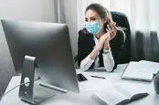 Someone working in an office while wearing a mask