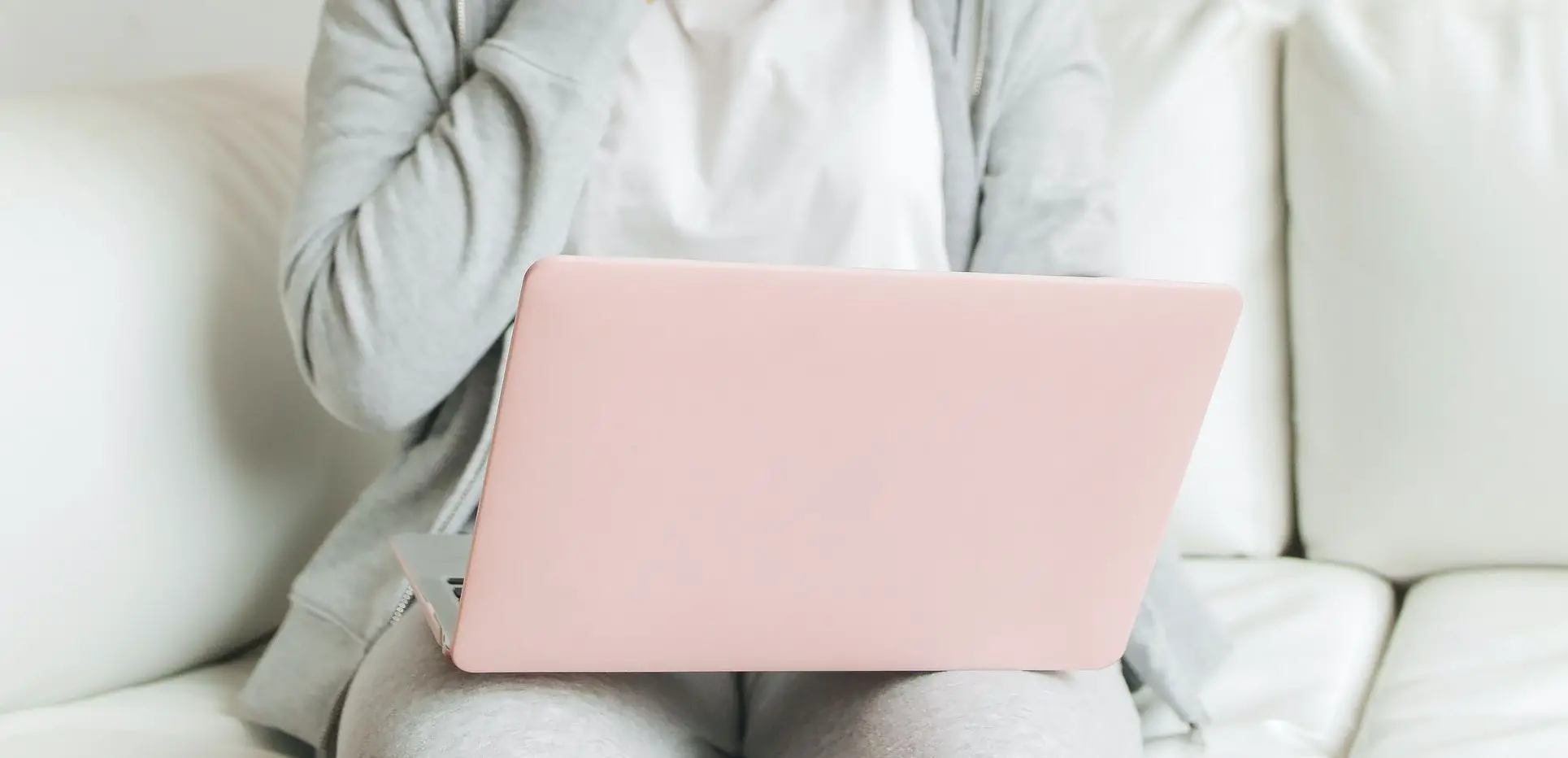 pink laptop cover on lap